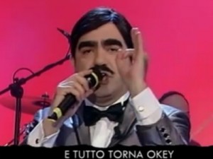 Elio a Parla con Me canta Lamped-USA dopo l'arrivo di Berlusconi sull'isola.