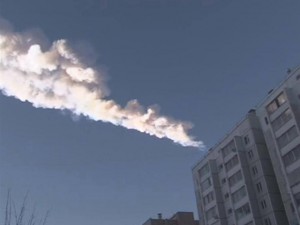 Still image from video shows the trail of a falling object above a residential apartment block in the Urals city of Chelyabinsk